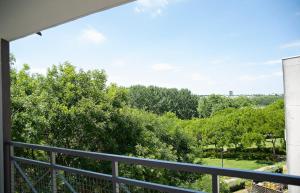 a balcony with a view of trees at Next to Disney Appart' Le Rêve Bleu in Torcy
