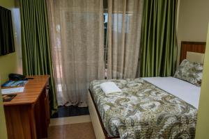 Postel nebo postele na pokoji v ubytování Vert Garden Hotel