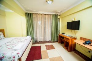 TV a/nebo společenská místnost v ubytování Vert Garden Hotel