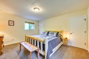 a bedroom with a bed and a table in it at 5 Mi to Mt Rainier Natl Park Cozy Cabin with Deck! in Ashford