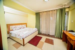 Postel nebo postele na pokoji v ubytování Vert Garden Hotel