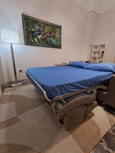 a bed in a room with a painting on the wall at Domus Solis Salento in Campi Salentina +52 photos