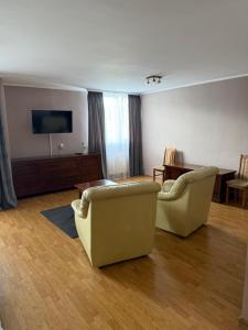 a living room with two couches and a tv at Polonez Pieczyska in Koronowo