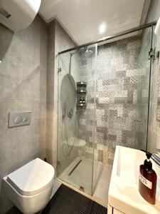 a bathroom with a shower and a toilet and a sink at NESK STAY Gauthier in Casablanca +77 photos