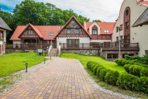 a large house with a brick driveway at Hotel Aubrecht Country Spa Resort in Przechlewo