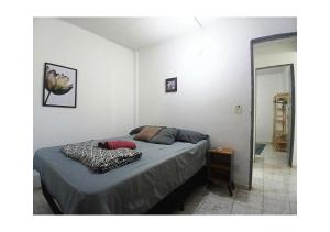 a bedroom with a bed in a room at Apto 02 quartos com ar ao lado do Parque das Águas in Cuiabá +6 photos