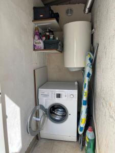 a washer and dryer in a small room at Holiday House Ljubica - ideal vacation spot in Bol