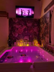 Cette chambre dispose d'une télévision et d'une baignoire avec des lumières violettes. dans l'établissement Al Baglio Apartments, à Partinico 32 autres photos
