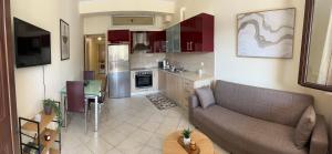a living room with a couch and a kitchen at Vathi Seaside Apartment in Meganisi +12 photos