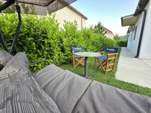 two chairs and a table in a yard at Apartman T&T in Cetinje