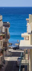 a car driving down a street next to the ocean at Attico vista mare in centro in Gallipoli