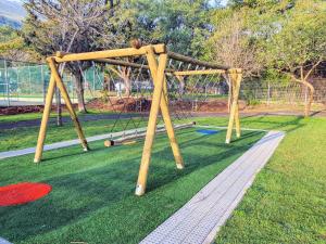 a playground with a swing set in a park at פינה למרגלות הגלבוע in Bet Alfa
