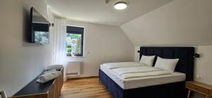 a small bedroom with a bed and a window at Apartments NIM in Jajce