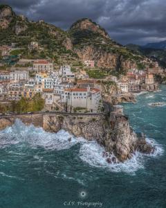 a town on a hill next to the ocean at Casa Margherita-Amalfi Coast in Furore