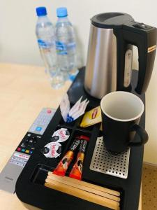 a black tray with a cup of coffee and chopsticks at Villa FOREST in Poznań