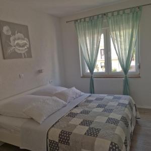 a bedroom with a bed and a window at Villa Natasa near Plitvice for 15 persons in Vrhovine