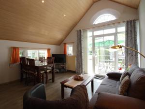 a living room with a couch and a table at Reihenhäuser in Strackholt in Strackholt
