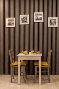 a table with chairs and a table with food on it at Roel Boutique B&B in Cospicua