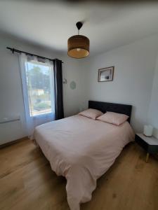 a bedroom with a large bed and a window at Les pivoines Notre-Dame-de-Monts in Notre-Dame-de-Monts +23 photos