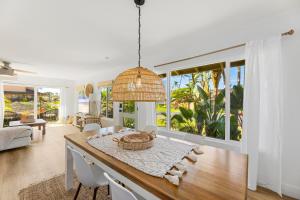a dining room with a table with a basket at Puamana 111-2 Superior Ocean View in Lahaina