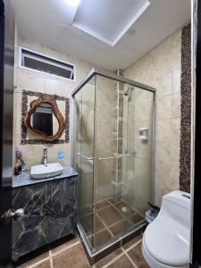 a bathroom with a shower and a toilet and a sink at hospedaje El patio in Salento +47 photos