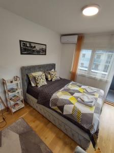 a bedroom with a bed in a room at Apartman Natura in Vrnjačka Banja +50 photos