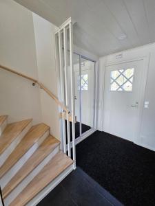 una stanza vuota con scale che conducono ad una porta di Heim Apartments - Rivitalo a Seinäjoki