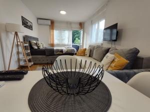 a living room with a couch and a table at Apartman Natura in Vrnjačka Banja