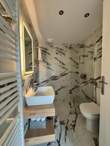 a bathroom with a sink and a toilet at Anemomilos in Samos