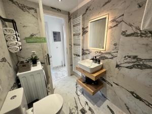a bathroom with a sink and a toilet and a mirror at Anemomilos in Samos +12 photos