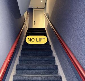 a no lift sign on the stairs in an elevator at The Old Nickel Hotel in Amsterdam