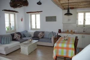 a living room with a couch and a table at The Weaver's house in Kithnos