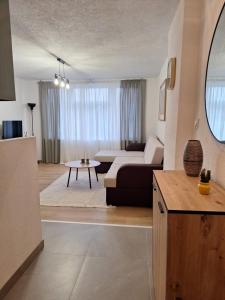 a living room with a couch and a table at Apartman KULA Livno in Livno