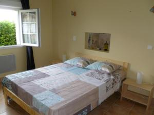 een slaapkamer met een bed in een kamer met een raam bij La grange in Saint-Germain-de-Lusignan