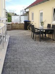 a patio with a table and chairs on it at Ferienwohnung am Bodensee- Preiswert in Überlingen +6 photos