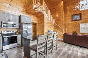 a kitchen with a counter and chairs in a cabin at Wild Heart Lodge cabin in Sevierville +44 photos