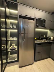 a stainless steel refrigerator in a kitchen at Flat Crystal Place 209 in Goiânia