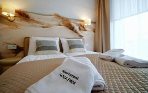 Postel nebo postele na pokoji v ubytování Apartments AQUA & SPA
