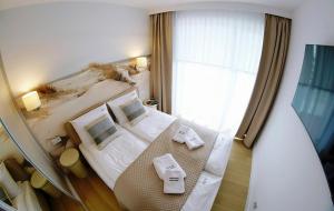 Postel nebo postele na pokoji v ubytování Apartments AQUA & SPA