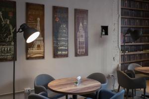 a room with tables and chairs and posters on the wall at 日月潭 3JD home 一館 in Yuchi