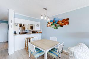 a kitchen and dining room with a table and chairs at ABPAB89 A Place at the Beach 355 in Atlantic Beach +14 photos