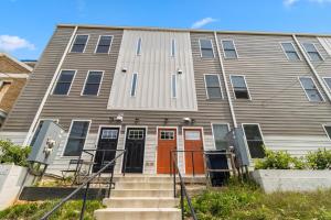a house with orange doors and stairs in front at Modern & Spacious 3bd 3ba RoofDeck in Washington