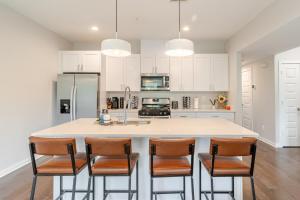 a kitchen with a large island with chairs around it at Modern & Spacious 3bd 3ba RoofDeck in Washington