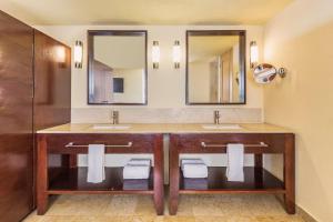 a bathroom with two sinks and two mirrors at Grand Fiesta Americana Los Cabos All Inclusive Golf & Spa in Cabo San Lucas