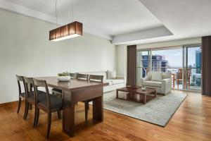 a dining room with a table and a living room at JW Marriott Hotel & Suites Saigon, The Apartments in Ho Chi Minh City +39 photos
