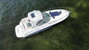 a white boat sitting in the water at Searay 320 in Miami