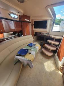 a living room with a table and chairs in an rv at Searay 320 in Miami
