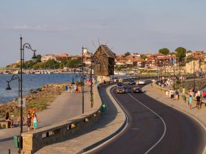a road with cars on it next to a beach at VIGO Nessebar in Nesebar +4 photos