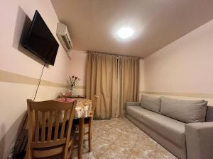 a living room with a couch and a table at VIGO Nessebar in Nesebar