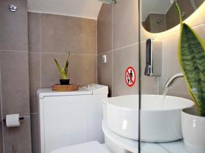 a bathroom with a toilet and a sink at Villa Jenny Stylianou in Spetses +65 photos